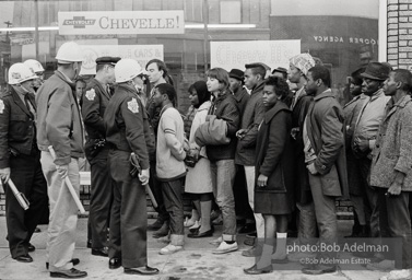 Police blocking demonstrators from approaching the courthouse in downtown, Selma, 1965.