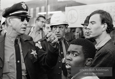 Police blocking demonstrators from approaching the courthouse in downtown, Selma, 1965.