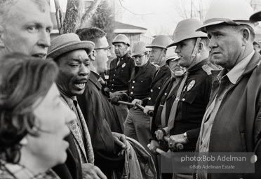 Stand-off: Sheriff Jim Clark's posse form a barrier, facing off with protestors who chant Stand-off: Sheriff Jim Clark's posse form a barrier, facing off with protestors who chant