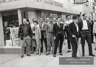 Hecklers stand together shouting insults as demostrators and participants of a voting rights drive pass by. Selma, AL, 1965.