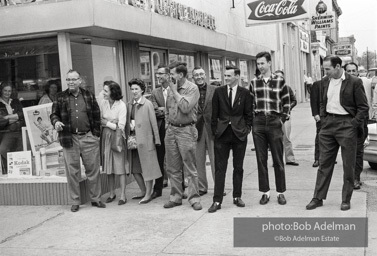 Hecklers stand together shouting insults as demostrators and participants of a voting rights drive pass by. Selma, AL, 1965.