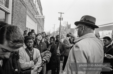 Police blocking demonstrators from approaching the courthouse in downtown, Selma, 1965.