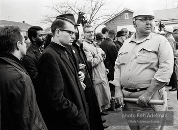 Stand-off: Sheriff Jim Clark's posse form a barrier, facing off with protestors who chant Stand-off: Sheriff Jim Clark's posse form a barrier, facing off with protestors who chant