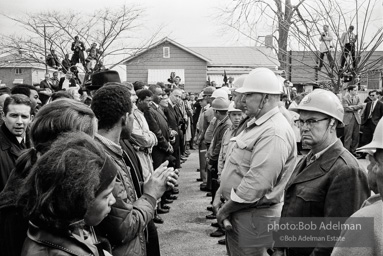 Stand-off: Sheriff Jim Clark's posse form a barrier, facing off with protestors who chant Stand-off: Sheriff Jim Clark's posse form a barrier, facing off with protestors who chant