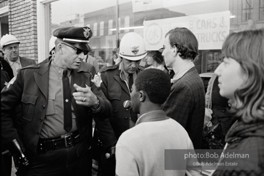 Police blocking demonstrators from approaching the courthouse in downtown, Selma, 1965.