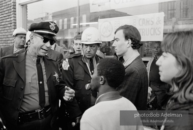 Police blocking demonstrators from approaching the courthouse in downtown, Selma, 1965.