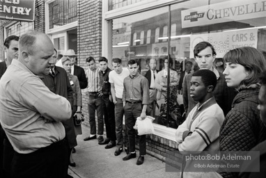 Police blocking demonstrators from approaching the courthouse in downtown, Selma, 1965.