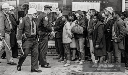 Police blocking demonstrators from approaching the courthouse in downtown, Selma, 1965.