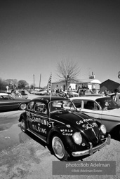 USA. Alabama.  1965. A VW Bug flies a Conferderate flag and is covered with racist graffiti along the road during the Martin Luther KING Jr.-led Selma to Montomery March. Many of the whites who came out to watch the march were hostile and jeered the marchers.
