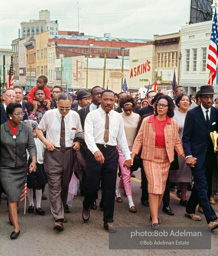 Leading a throng of 25,000 marchers, King enters the downtown, Montgomery, Alabama.  1965