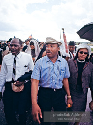 Braving the rain, Martin Luther King leads the Selma to Montgomery march as it approaches it's finale in Montgomery, Alabama. 1965