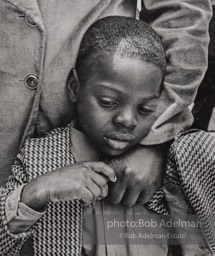 Comforted by a day-care worker. Harlam, New York City. 1978.