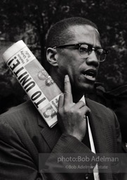 Malcolm X at a civil rights demonstration, Brooklyn, New York City.  1963-


“He was a fiery orator. No one could give tongue to the grievous wrongs suffered by African Americans in white America more trenchantly
than Malcolm. To get his message out to the assembled press, he
showed up at civil rights demonstrations as the photographer for The Messenger. We sometimes
discussed cameras and f- stops. I was surprised when he asked me how I thought the Black Muslim faith compared to Islam.
Emphasizing my limited knowledge, I very hesitantly favored Islam — it welcomed all races and was older and wiser. Some
time later he converted to Islam, which was a great revelation for him but, tragically, led to his assassination.”