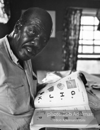 Getting the word: Ollie Robinson, an unemployed farmworker, learns to read,  the Mississippi Delta, Mississippi.  1965 Fortune  magazine