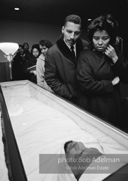 With Allah: Sheathed in accordance with Islamic tradition, the slain martyr is viewed by thousands, Harlem, New York City.   1965