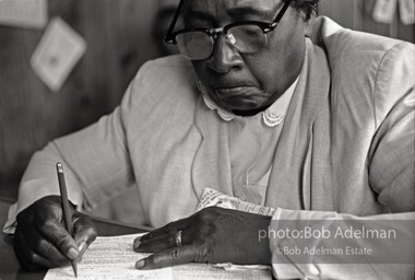 Woman filling out a sample registration form in Frank Robinson’s office, Sumter, SC 1962