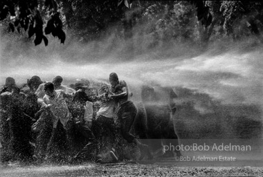 No man is an island,  Kelly Ingram Park,  Birmingham, Alabama. 1963


“The police and firemen used a brute show of force to try to stop the ongoing demonstrations. It didn’t work on this day. Rather than fleeing, the protestors hung on to each other and were able to stand up to the full fury of the water, though not without casualties. I have never witnessed such cruelty. There was almost as much moisture behind the lens as in front. I gave a print of this picture to Dr. King. He studied it and said, ‘I am startled that out of so much pain some beauty came.