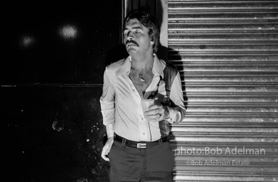 A high After-hours club goer rests on his way home just before dawn . New York City, 1978.