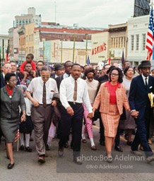 Leading a throng of 25,000 marchers, King enters the downtown, Montgomery, Alabama.  1965