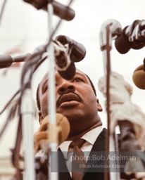 King before a forest of microphones as he addresses the crowd, Montgomery 1965