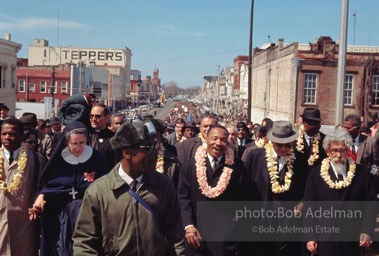 Crossing over: King leads the Montgomery-bound marchers over the Edmund Pettus Bridge, which was already famous for shocking scenes of police brutality,   Selma,  Alabama.  1965