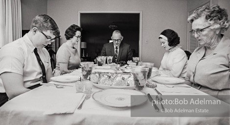 Pause in prayer, giving thanks for the meal they are about to receive. Sumter, South Carolina. 1967.