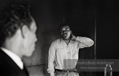 A candidate ponders what he’s hearing as voter-registration organizer Frank Robinson offers assistance,  Sumter,  South Carolina.  1962