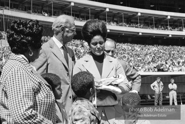 Opening day. Mrs. Clement receives her husband's uniform. From the book Opening day. Mrs. Clement receives her husband's uniform. From the book