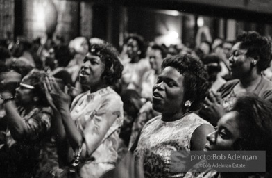 The audience responds as Martin Luther King and Ralph Abernathy speak at the 16th Stret Baptist Church. Birmingham Alabama, 1963.