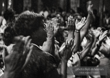 The audience responds as Martin Luther King and Ralph Abernathy speak at the 16th Stret Baptist Church. Birmingham Alabama, 1963.