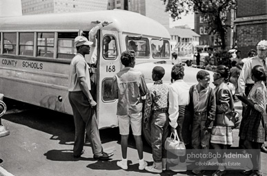 Arrested protestors are loaded onto a bus and taken to a detention center. Birmingham, AL, 1963.