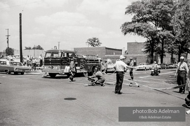 Setting up the high-powered water cannons which were turned on the protestors in Kelly Ingram Park. Birmingham, AL, 1963.