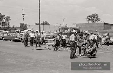 Setting up the high-powered water cannons which were turned on the protestors in Kelly Ingram Park. Birmingham, AL, 1963.