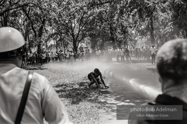 Woman onlooker being hosed near Kelly Ingram Park, Birmingham 1963