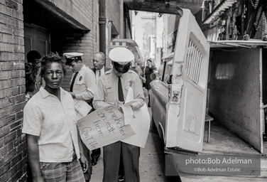 An arrest outside Loveman's Department Store. Birmingham,  Alabama.  June, 1963.