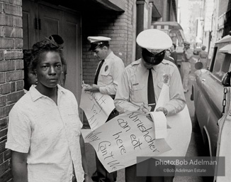 An arrest outside Loveman's Department Store. Birmingham,  Alabama.  June, 1963.