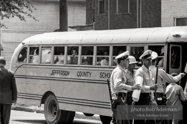 Arrested protestors are loaded onto a bus and taken to a detention center. Birmingham, AL, 1963.