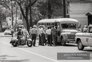 Arrested protestors are loaded onto a bus and taken to a detention center. Birmingham, AL, 1963.