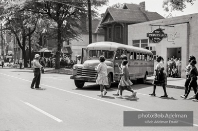 Arrested protestors are loaded onto a bus and taken to a detention center. Birmingham, AL, 1963.