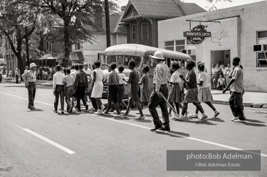 Arrested protestors are loaded onto a bus and taken to a detention center. Birmingham, AL, 1963.