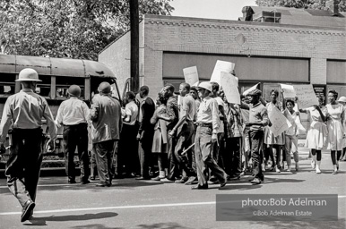 Arrested protestors are loaded onto a bus and taken to a detention center. Birmingham, AL, 1963.