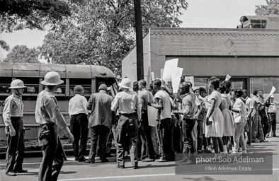 Arrested protestors are loaded onto a bus and taken to a detention center. Birmingham, AL, 1963.