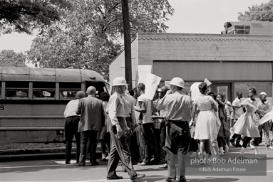 Arrested protestors are loaded onto a bus and taken to a detention center. Birmingham, AL, 1963.