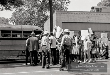 Arrested protestors are loaded onto a bus and taken to a detention center. Birmingham, AL, 1963.