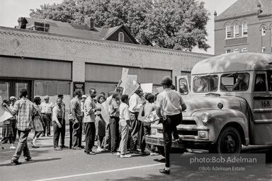 Arrested protestors are loaded onto a bus and taken to a detention center. Birmingham, AL, 1963.