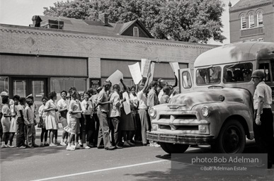 Arrested protestors are loaded onto a bus and taken to a detention center. Birmingham, AL, 1963.