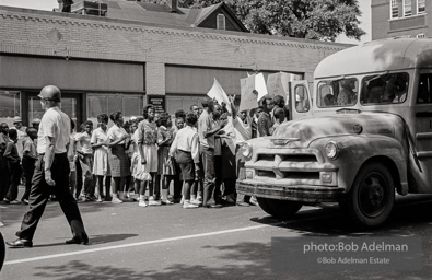 Arrested protestors are loaded onto a bus and taken to a detention center. Birmingham, AL, 1963.