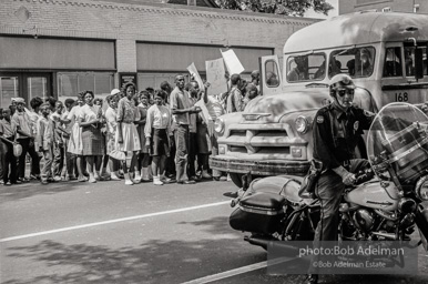 Arrested protestors are loaded onto a bus and taken to a detention center. Birmingham, AL, 1963.