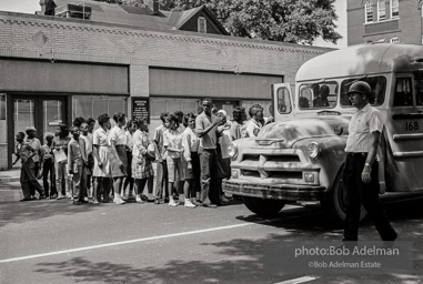 Arrested protestors are loaded onto a bus and taken to a detention center. Birmingham, AL, 1963.