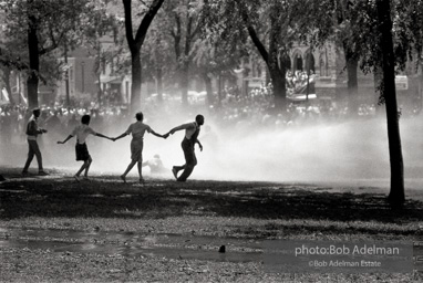 Demonstrators hold onto each other to face the spray, Kelly Ingram Park, Birmingham 1963.